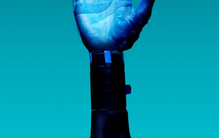 alt="Free Prosthetic Arm on Blue Background Stock Photo"