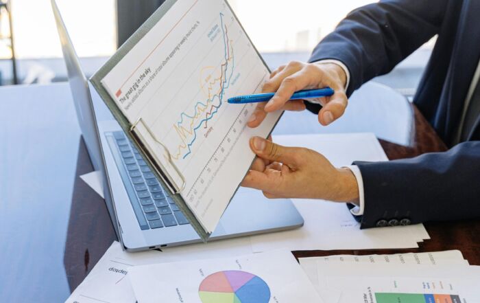 Free Business professionals discussing financial graphs and charts in an office setting. Stock Photo